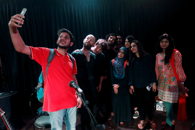 Fans take a selfie with the members of French band ESHARET after a concert at the Alliance Francaise in Karachi, Pakistan.